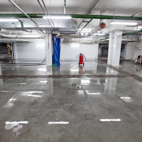 Inside of car wash Inside shot of car washing area with glowing lamps reflecting light in wet floor.